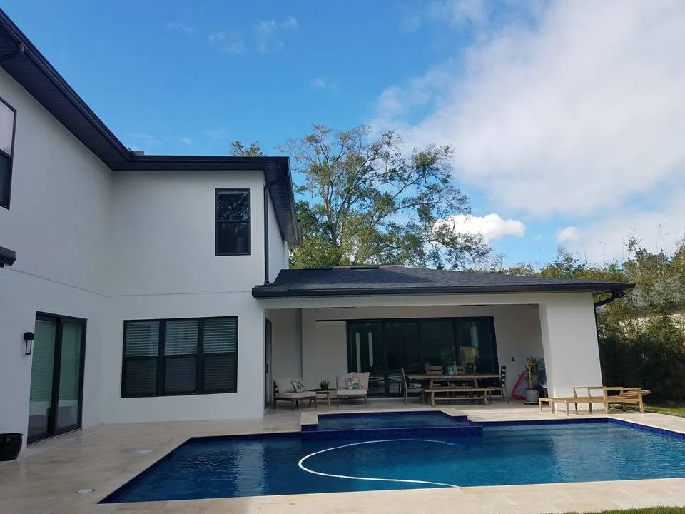 Rear pool covered lanai black fascia gutters white stucco, Sanford